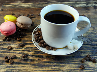 Coffee and macarones on table.