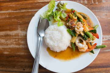 Thai food: stir-fried seafood with chili and herbs with rice