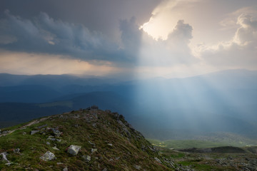 Carpathian Mountains. The rays breaking through the clouds illuminating the ground