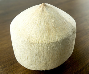 Fresh young coconut with white fibrous husky shell