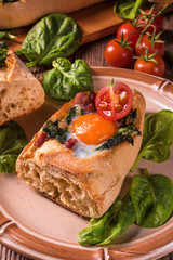 Fototapeta na wymiar farmer baguette filled with egg, bacon and spinach