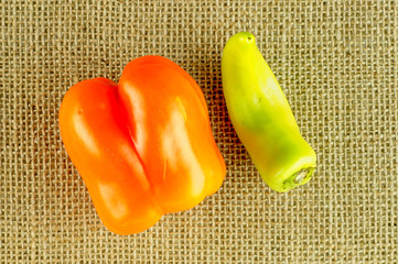 Overhead shot of orange capsicum and yellow wax pepper