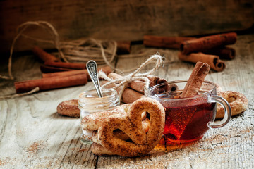 Black tea and cookies with cinnamon, selective focus