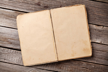 Open vintage book on wood