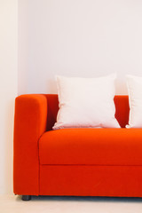 Red sofa with pillow and light lamp