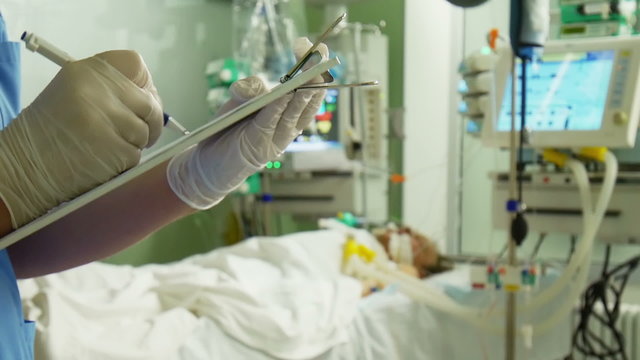 Doctor Writing Medical Prescription and Patient on Background