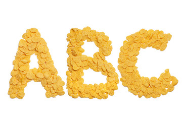 abc letters made of cornflakes over white background