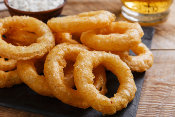 fried onion rings in batter with sauce