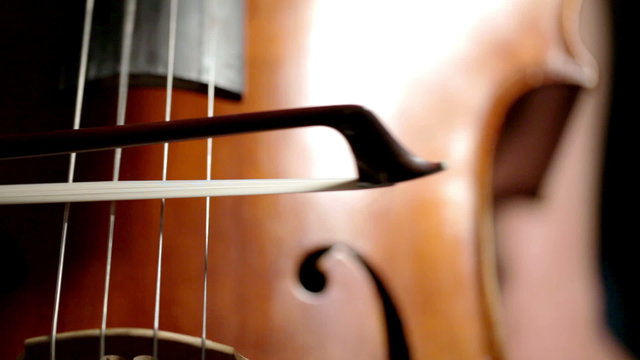 Cellist bowing; detail of bowing technique on strings