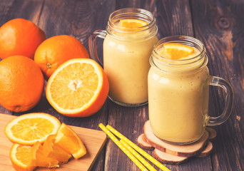 Orange fruit smoothie in the glass jars