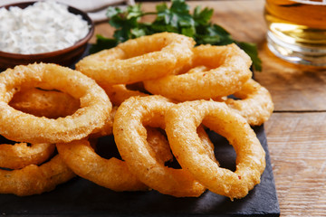 fried onion rings in batter with sauce