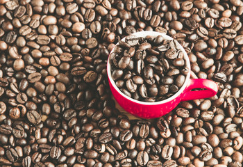  red cup of coffee on beans, contrast toned