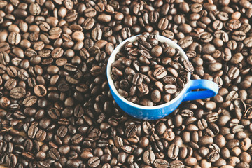 Cup of coffee on beans, contrast toned