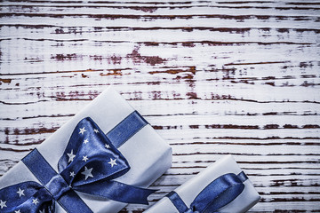 Gift containers with blue present tapes on vintage wooden board