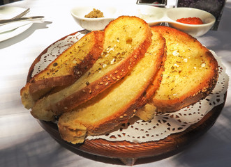 toasted bread on a wooden plate