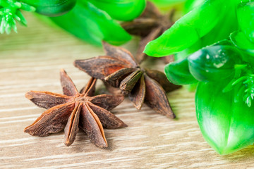 Spices. Anise stars on the vintage wooden surface. Selective focus.