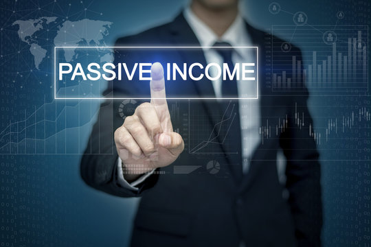 Businessman hand touching PASSIVE INCOME button on virtual scree