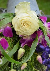 bouquet of white roses and colorful flowers in metal can