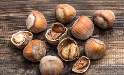 Hazelnuts on a wooden background.