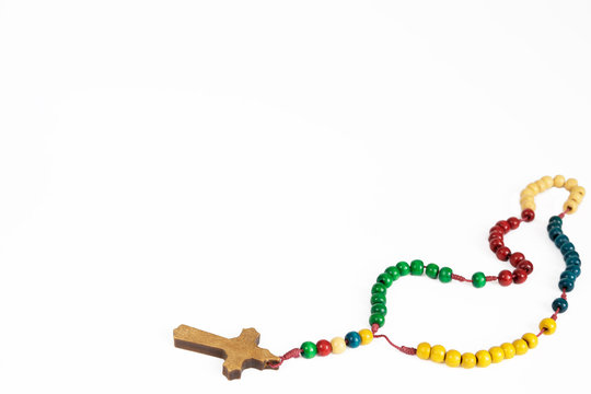 Wooden, colorful  rosary necklace isolated on white background.