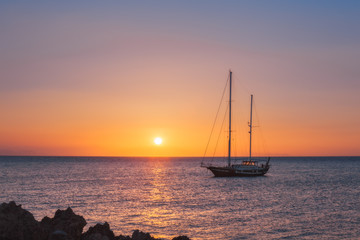 Yacht at sunrise in the Mediterranean Sea. Rhodes Island. Greece