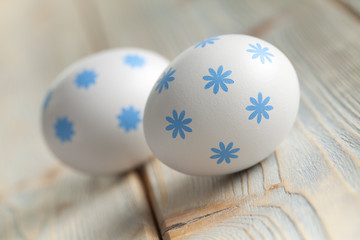 Two Easter eggs on wooden planks