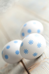 Three Easter eggs on wooden background