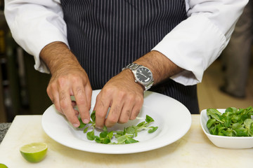Chef is mixing salad