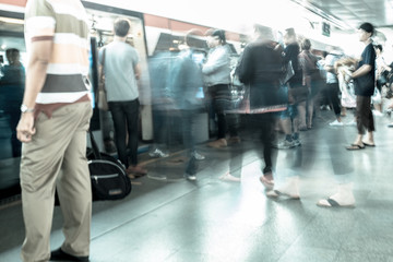 Motion blur people walking in train station