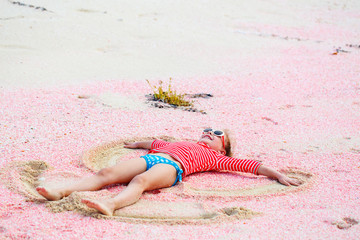 Girl making sand angel