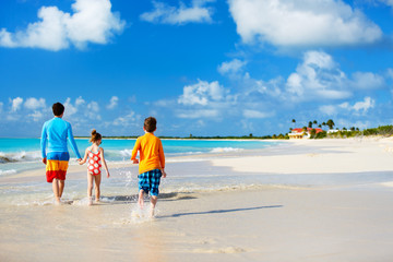 Father with kids at beach