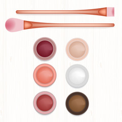 Set of colored blushers and brushes on white wooden table