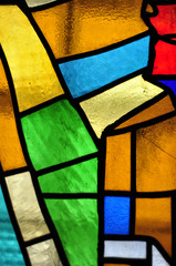 Image of a multicolored stained glass window with irregular bloc