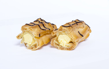 Eclairs with chocolate on white background
