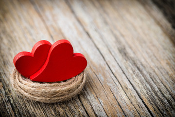Red heart-shaped on a wooden background.