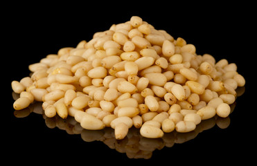 Pile of pine nuts isolated on black background