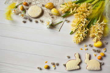 Easter background with flowers, cakes and eggs