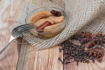 Pear Compote with Fork on Wooden Table with Star Anise & Cloves