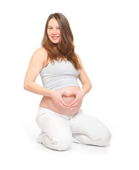 Young woman with hands forming on belly. People isolated on white background. Maternity and healthcare concept.