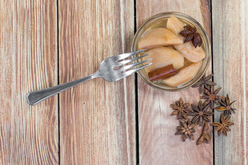 Top View on a Pear Compote on Wooden Table with Star Anise & Cin
