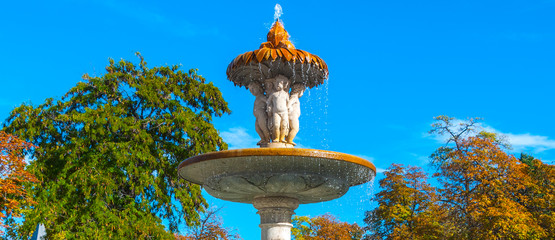 Lovely fountains in the city of Madrid's Retiro park.   

Flowing fountains in Retiro Park, the main park of the city of Madrid, Spain on a warm November day.