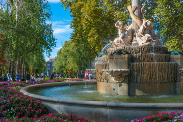 Lovely fountains in the city of Madrid's Retiro park.   

Residents and tourists enjoying flowing fountains in Retiro Park, the main park of the city of Madrid, Spain on a warm November day.