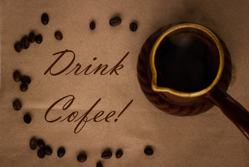 cofee beans seeds on brown paper background and clay pot, drink