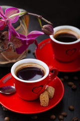 Red cup of coffee and coffee beans