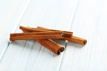 Cinnamon on a blue wooden background