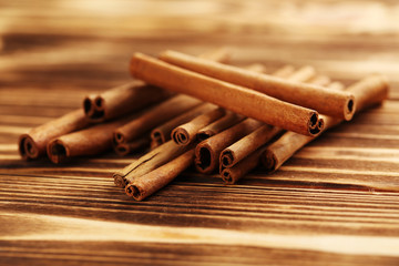 Cinnamon on a brown wooden background