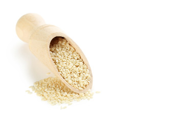 Sesame seeds with scoop isolated on a white
