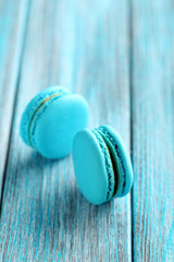 Tasty blue macarons on a blue wooden table