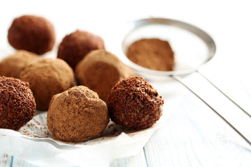 Sweet chocolate truffle on a blue wooden table