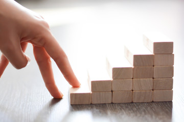 Careers level concept with wooden blocks made by stairs in the white isolated background